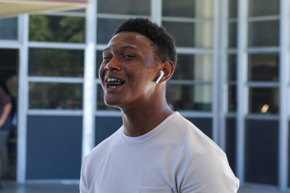 A candid shot of Aguilar celebrating with a smile looking like a lighthearted victory.