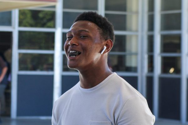 A candid shot of Aguilar celebrating with a smile looking like a lighthearted victory.