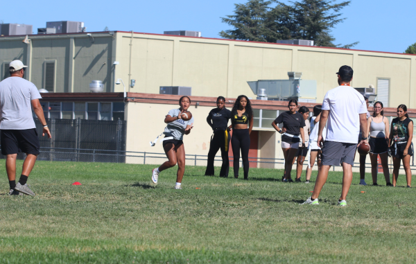 Aarolyn Fields, sophomore at Seca and new Stagg Flag Football Varsity player, demonstrates how to receive a ball in play.