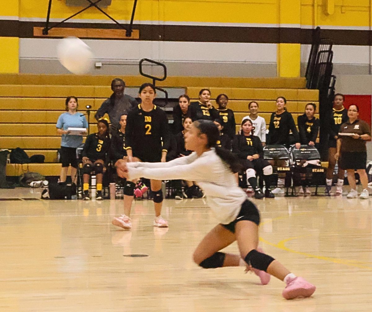 Alyisah Smith(#1) receives the ball, in this case, saves it from hitting the ground.