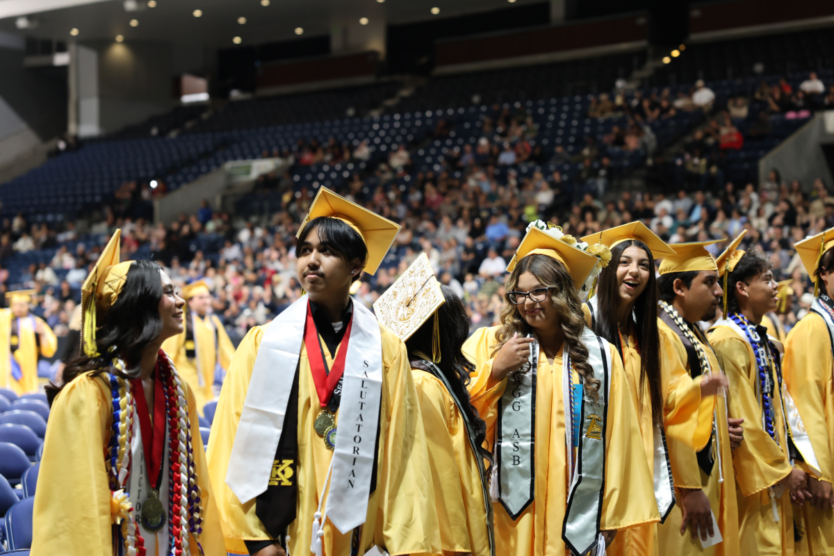 Graduates take in the moment around them as they wait for their fellow graduating peers to take their seats.